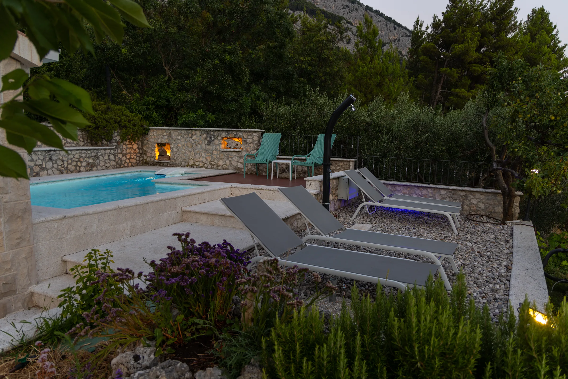Private pool and stone terrace at Villa Dalmatia at dusk