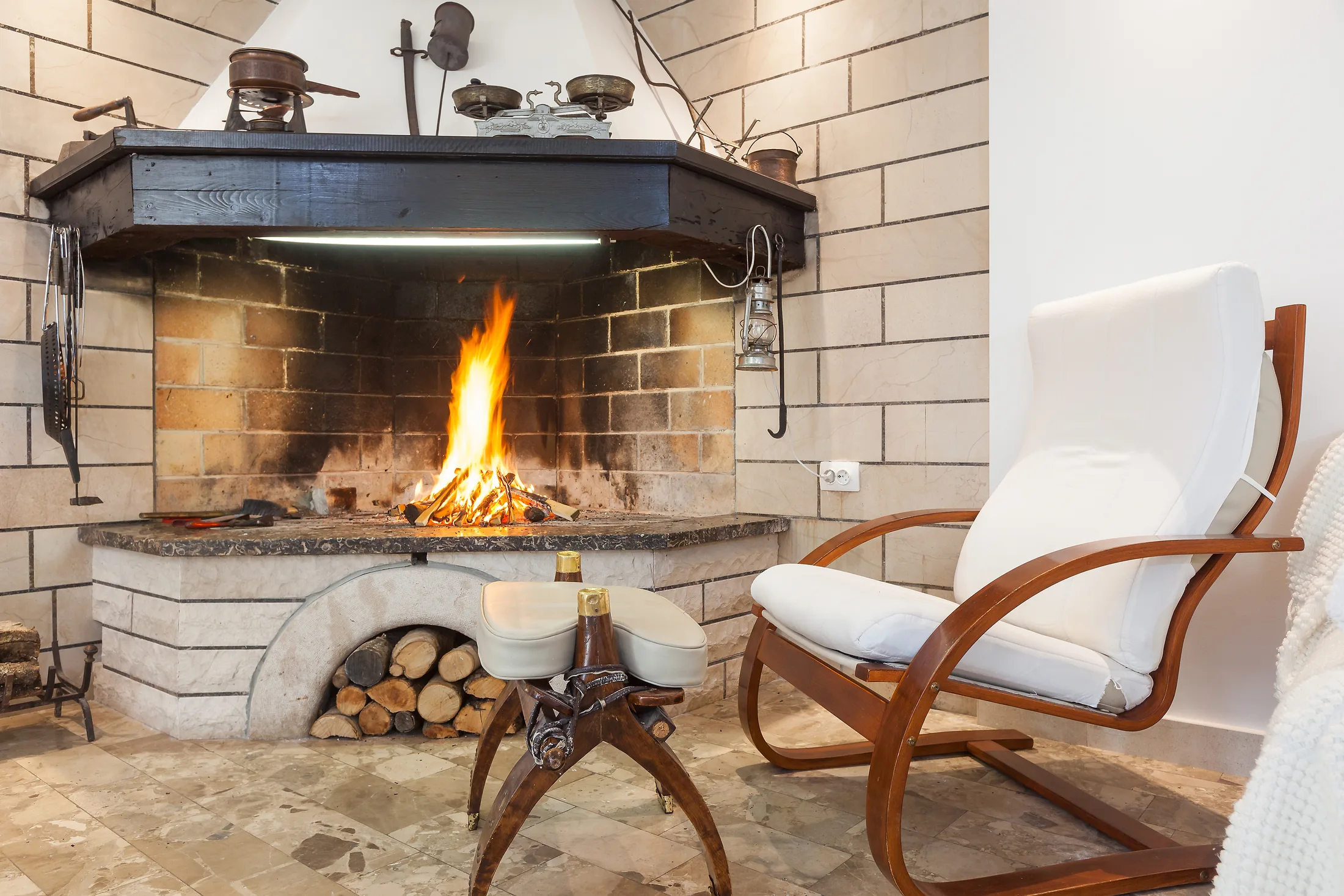 Lit stone fireplace inside Villa Dalmatia